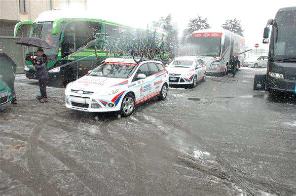 team cars and busses in the snow